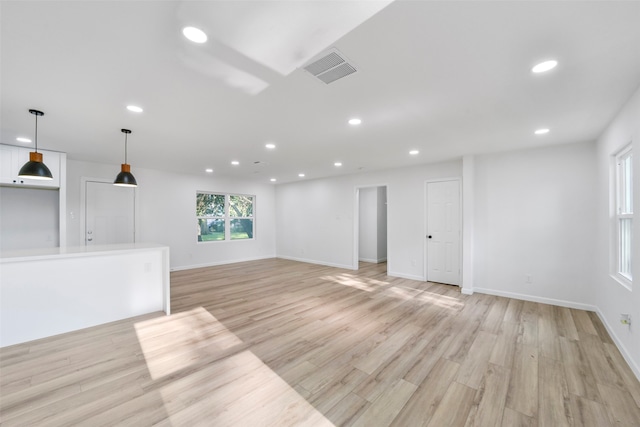 unfurnished living room with light wood-type flooring