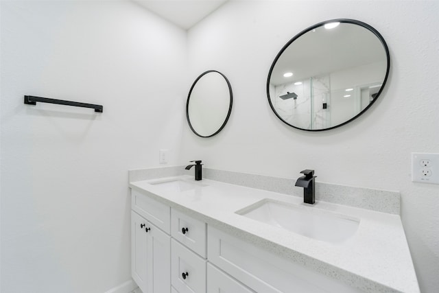 bathroom featuring walk in shower and vanity