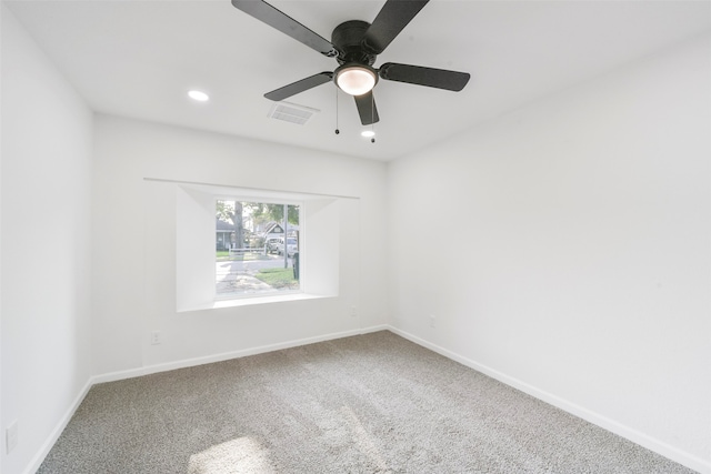 carpeted spare room featuring ceiling fan