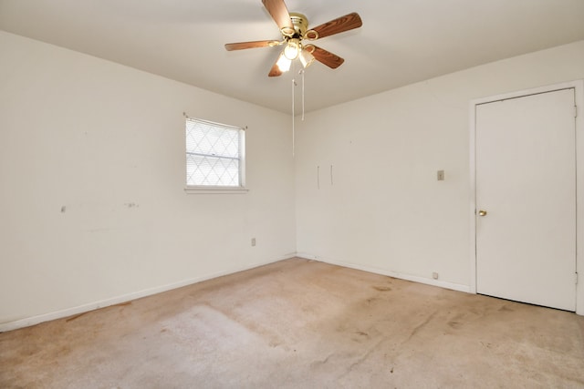 empty room with ceiling fan and light carpet