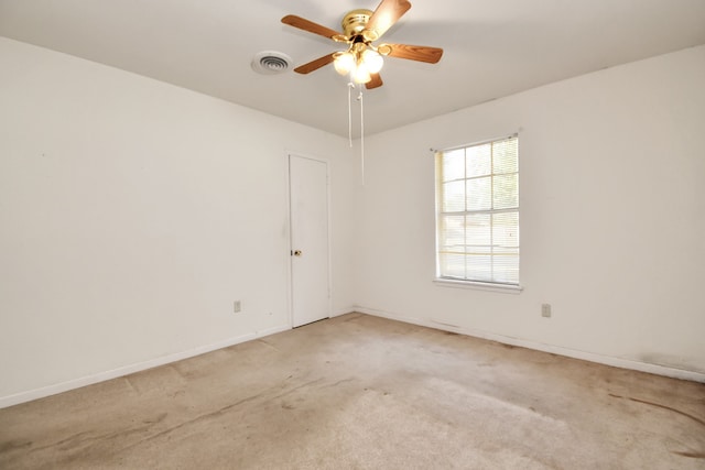 spare room with ceiling fan and light colored carpet