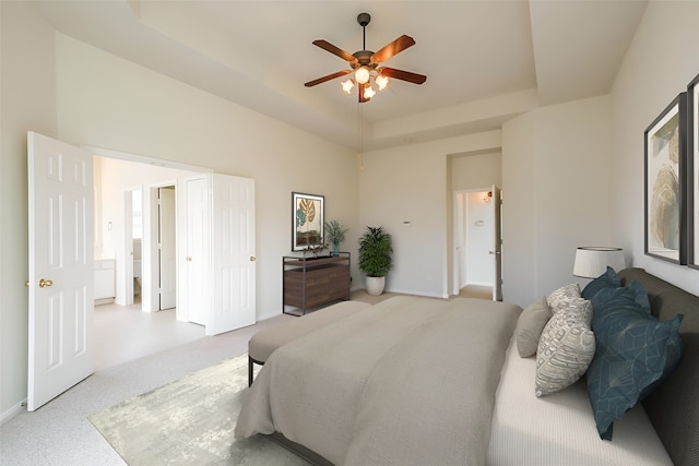 bedroom featuring a ceiling fan, a raised ceiling, carpet, and baseboards