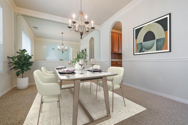 carpeted dining room featuring ornamental molding, arched walkways, a notable chandelier, and visible vents