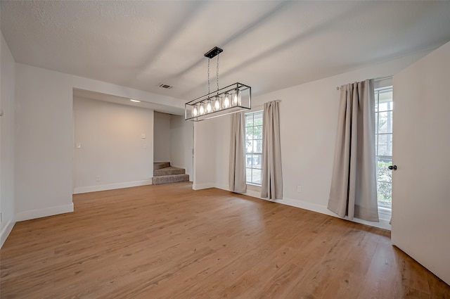 unfurnished dining area featuring a healthy amount of sunlight and light hardwood / wood-style flooring