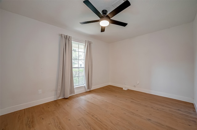 unfurnished room featuring ceiling fan and light hardwood / wood-style floors