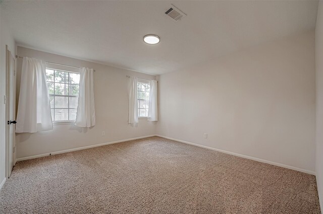 carpeted empty room with a healthy amount of sunlight