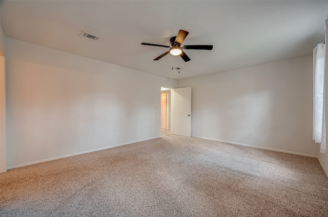 spare room with carpet flooring and ceiling fan