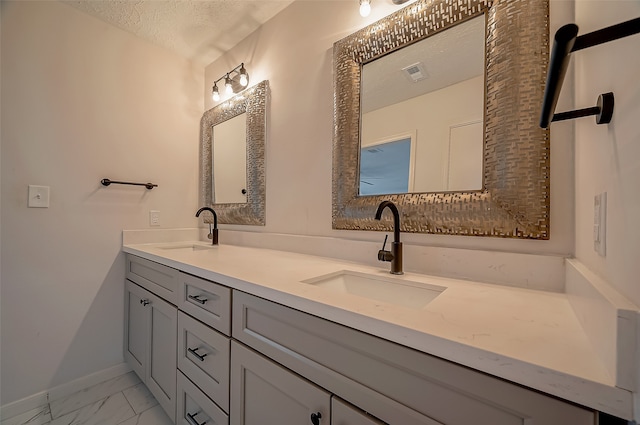 bathroom with vanity and a textured ceiling