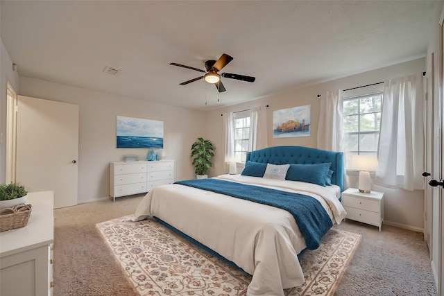 bedroom with light carpet and ceiling fan