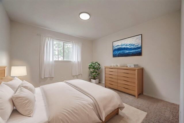 bedroom featuring light carpet