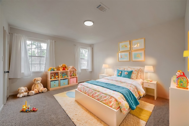 bedroom with carpet floors and multiple windows