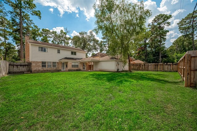 back of house featuring a lawn