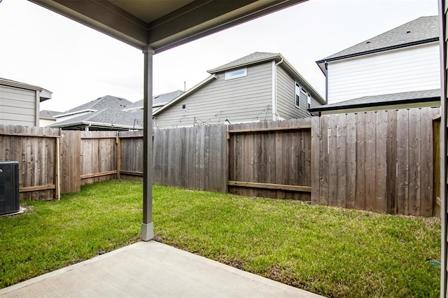 view of yard with central AC and a patio area