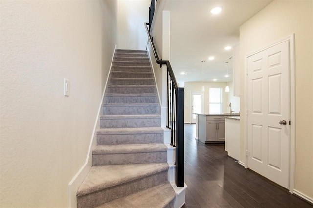 stairs featuring wood-type flooring