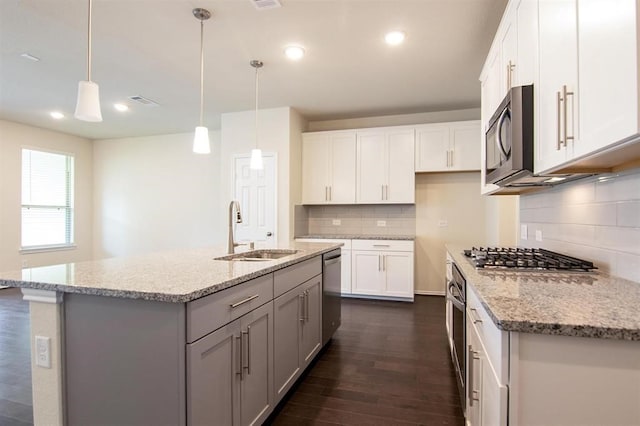 kitchen featuring sink, dark hardwood / wood-style flooring, stainless steel appliances, and white cabinets