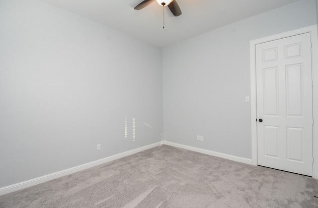 spare room featuring ceiling fan, baseboards, and carpet floors
