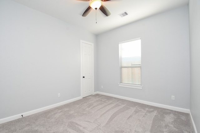 carpeted spare room with ceiling fan