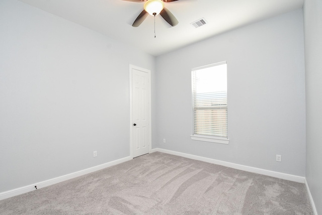 spare room featuring visible vents, a ceiling fan, carpet flooring, and baseboards