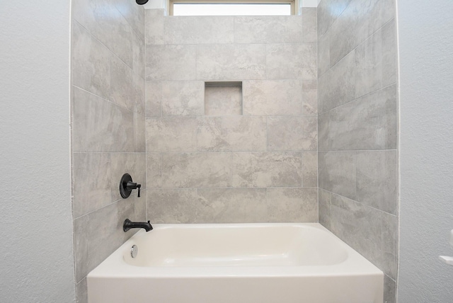 full bath with a textured wall