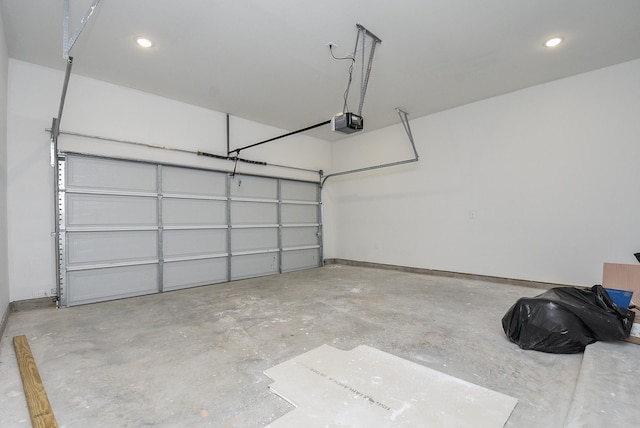 garage featuring baseboards, recessed lighting, and a garage door opener