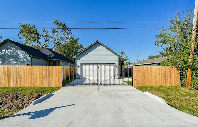 detached garage with fence and a gate