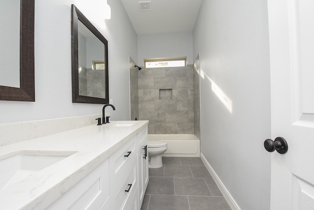 bathroom featuring a sink, double vanity, visible vents, toilet, and tile patterned floors