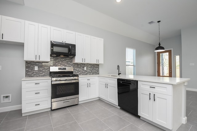 kitchen with kitchen peninsula, light tile patterned floors, white cabinetry, black appliances, and pendant lighting