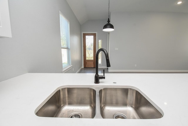 room details with decorative light fixtures, light countertops, and a sink