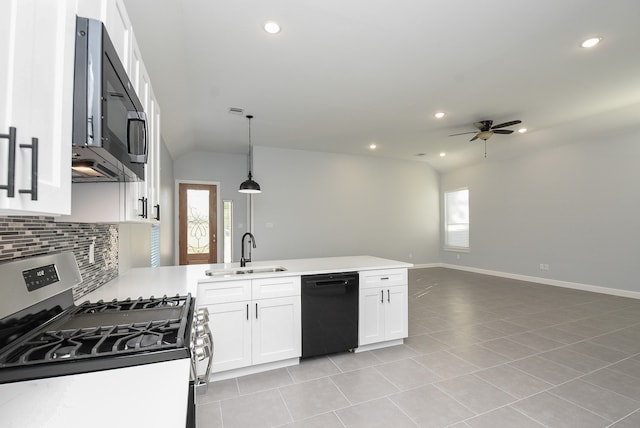 kitchen with sink, stainless steel appliances, lofted ceiling, pendant lighting, and white cabinets