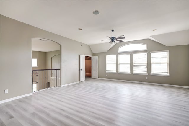 spare room featuring a wealth of natural light, vaulted ceiling, and ceiling fan