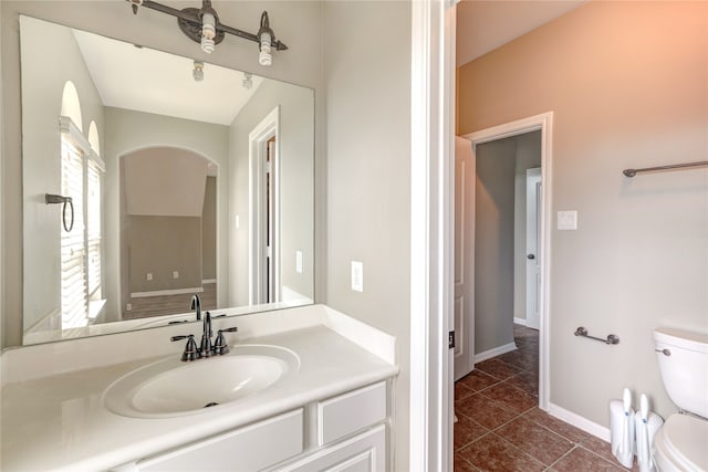 bathroom with vanity, tile patterned flooring, and toilet