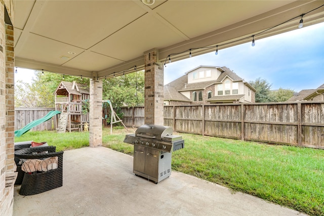 view of patio / terrace featuring area for grilling and a playground