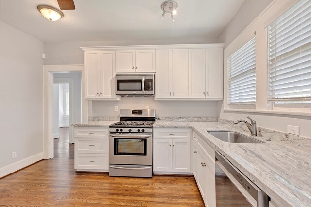 kitchen featuring stainless steel appliances and white cabinetry