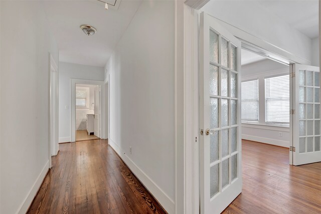 hallway featuring dark hardwood / wood-style floors and french doors