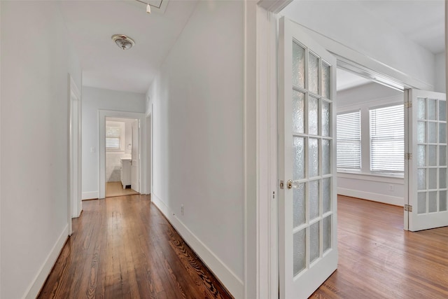 hallway with french doors and dark hardwood / wood-style flooring