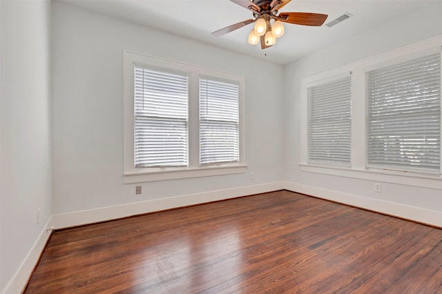 spare room with ceiling fan and dark hardwood / wood-style floors