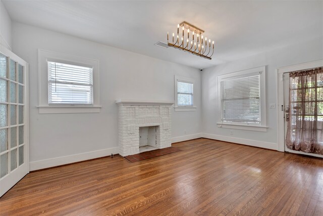 unfurnished living room featuring hardwood / wood-style floors, plenty of natural light, and a fireplace