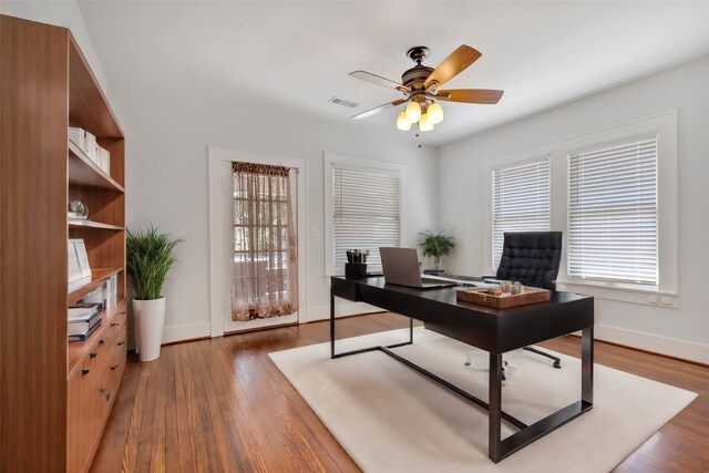 office area with dark hardwood / wood-style flooring and ceiling fan