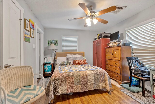 bedroom featuring wood-type flooring and ceiling fan