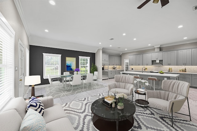 living room featuring ornamental molding, ceiling fan, light tile patterned floors, and sink