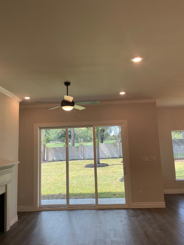 unfurnished living room featuring dark hardwood / wood-style floors and a wealth of natural light