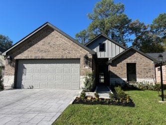 view of front of house with a front yard and a garage