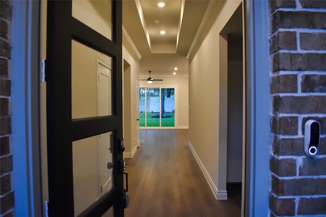 corridor with dark hardwood / wood-style flooring and ornamental molding