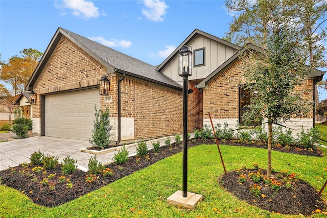 view of front of property featuring a garage and a front lawn