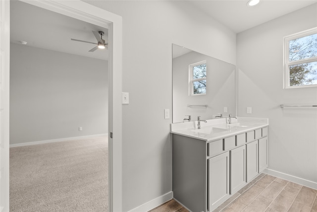 bathroom featuring vanity, ceiling fan, and a healthy amount of sunlight