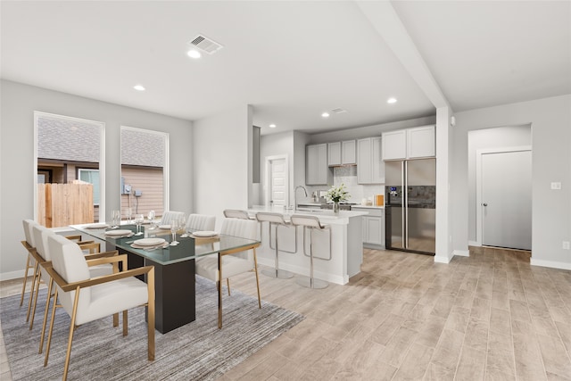 dining room featuring light hardwood / wood-style floors and sink