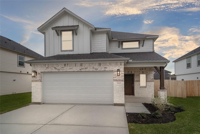 view of front of home featuring a shingled roof, concrete driveway, fence, board and batten siding, and brick siding