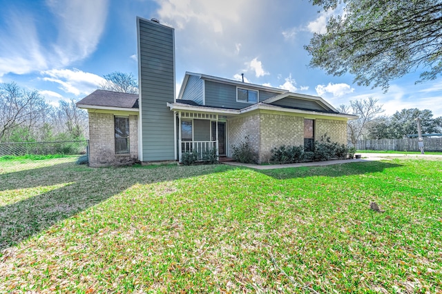 back of house featuring a lawn