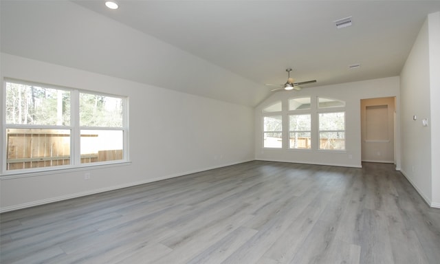 spare room with vaulted ceiling, ceiling fan, and light hardwood / wood-style flooring