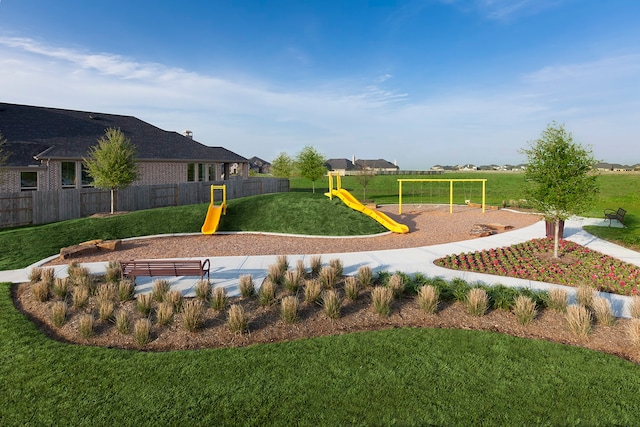 view of community with a lawn and a playground